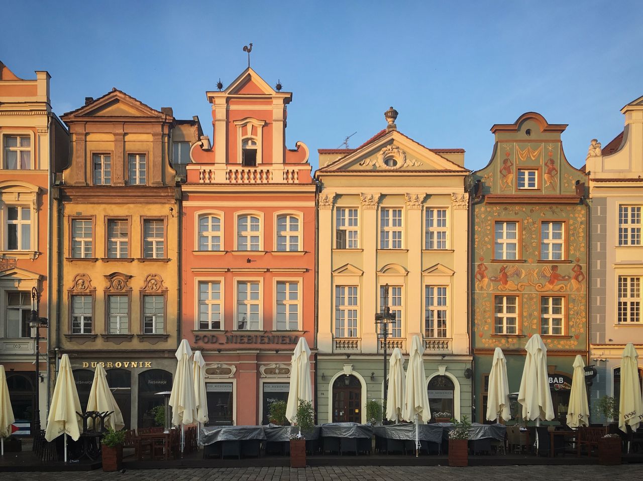 Charming colorful tenements in Poznań's Old Town Square, showcasing historic architecture.